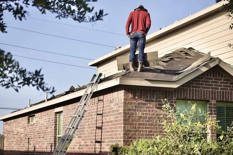 Professional roofer working on a residential roof in Violetville